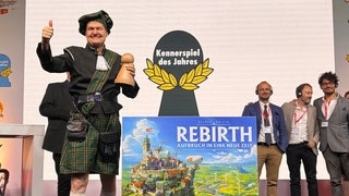 Reiner Knizia holte mit seinem Brettspiel "Rebirth" den Titel "Kennerspiel des Jahres 2026". Für ihn war es das Triple, er hat nun alle Preise in allen drei Kategorien der Jury "Spiel des Jahres" gewinnen können.