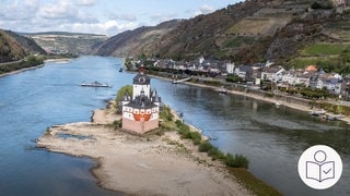 Ein Schiff fahrt auf dem Rhein bei Kaub. Im Rhein ist sehr wenig Wasser. Rechts das SWR Logo für Leichte Sprache.