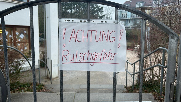 Ein Schild vor einem Kindergarten in Karlsruhe warnt vor Glatteis.