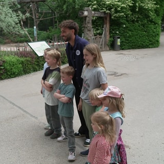 KSC-Profi posiert mit Kindern im Karslruher Zoo.
