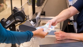 Die Verbraucherzentralen sind besorgt, dass es beim Einkaufen zunehmend Probleme mit Barzahlung geben könnte. Kaufland und Lidl stellen währenddessen immer mehr auf SB-Kassen um. 