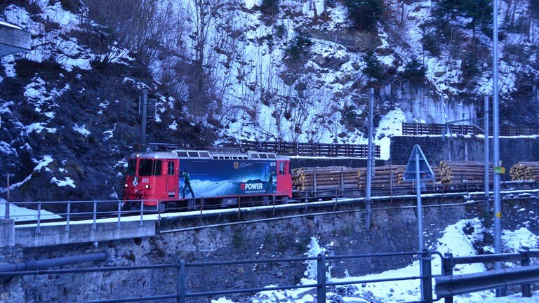 Güterzug am Ortseingang von Chur, daneben der Fluß Plessur