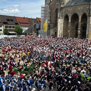 Tausende Musikerinnen und Musiker haben sich auf dem Ulmer Münsterplatz versammelt, um gemeinsam eines der letzten Konzerte des Deutschen Musikfests zu spielen.
