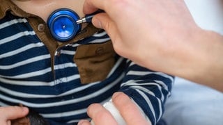 Ein Kinderarzt untersucht ein Kind mit einem Stethoskop. Eltern sind am Amtsgericht Horb angeklagt, weil sie ihr Kinde nicht zum Arzt gebracht und so fahrlässig seinen Tod verursacht haben sollen.