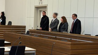 Angeklagter mit Verteidigern im Gerichtssaal. Vor dem Landgericht Koblenz muss sich ein Mann wegen Kokainhandels verantworten. 