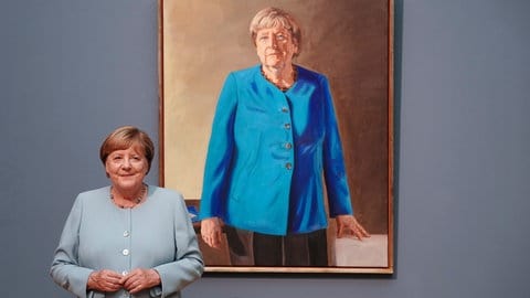 Angela Merkel, ehemalige Bundeskanzlerin, steht vor ihrem Porträt 
