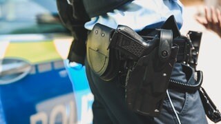 Eine Pistole am Holster eines Polizisten: In Wiesbaden hat die Polizei auf einen Mann geschossen. Sie war zuvor zu einem Fall von häuslicher Gewalt gerufen worden. (Symbolbild) 