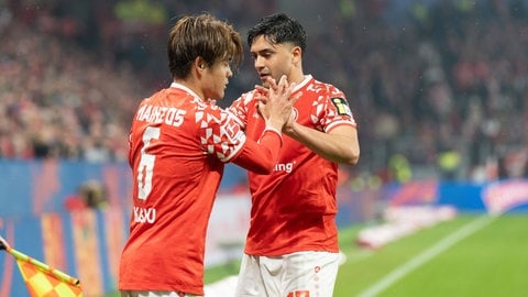 Kaishu Sano und Nadiem Amiri vom 1. FSV Mainz 05 klatschen sich ab.