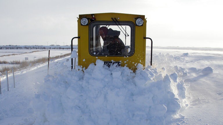Winterdienst: Bei so viel Schnee kommen die Männer vom Küstenschutz mit ihrer Schneepfluglok nur mit Mühe durch.