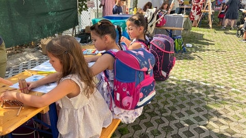 Angehende Erstklässlerinnen tragen ihren neuen Schulranzen zum ersten Mal.