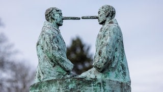 Skulptur "Die Lügner" (zwei männliche Figuren mit langen Pinocchio-Nasen) des niederländischen Künstlers Nicolas Dings in Osnabrück: Falsche Höflichkeit, Notlügen, das Verschweigen schmerzhafter Wahrheiten: Welches Verhältnis haben wir zur Wahrheit? 
