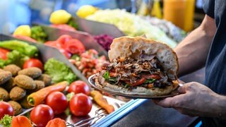 Ein Döner wird für einen Gast serviert. Wer in Baden-Württemberg in Zukunft plant, eine Kneipe, ein Restaurant oder ein Café zu eröffnen, soll weniger Formulare ausfüllen müssen. Die Bürokratie soll abgebaut werden.