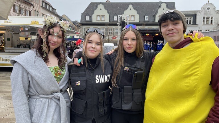 Eine Fee, die von zwei SWAT-Polizistinnen und einer Banane begleitet wird.