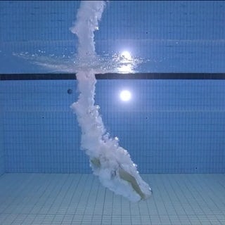 Tauchende Person in einem Schwimmbecken des Hirschbachbads