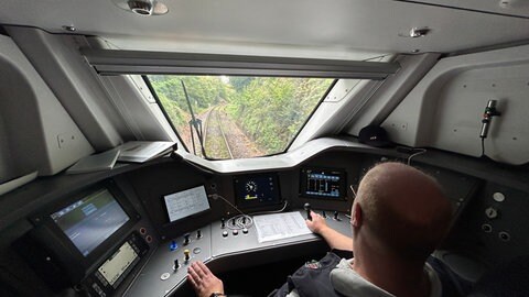 Blick aus dem Führerstand auf eine kurvige Waldstrecke