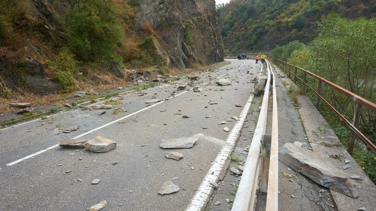 Steine und Felsstücke liegen auf der Fahrbahn der Bundesstraße B42 nach dem Felssturz an der Loreley.