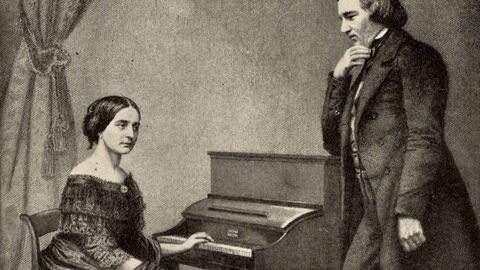 Clara Schumann am Klavier mit ihrem Mann Robert Schumann