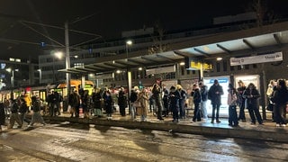 Reisende warten auf ihre Bahn in Heidelberg