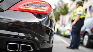 Eine Polizistin kontrolliert ein getunte Auto. Die Polizei hat in Bingen dutzende Autos aus dem Verkehr gezogen.