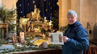 Clemens Krebs zeigt den Aushang vor der Krippe. Er hofft damit die Krippenfiguren wiederzubekommen.