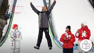 Der deutsche Ski·springer Philipp Raimund springt vom Podest in die Luft. Er freut sich über den Sieg bei den Olympischen Winter·spielen. Rechts das SWR Logo für Leichte Sprache.