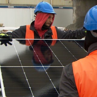 Solarmodule werden verschraubt.