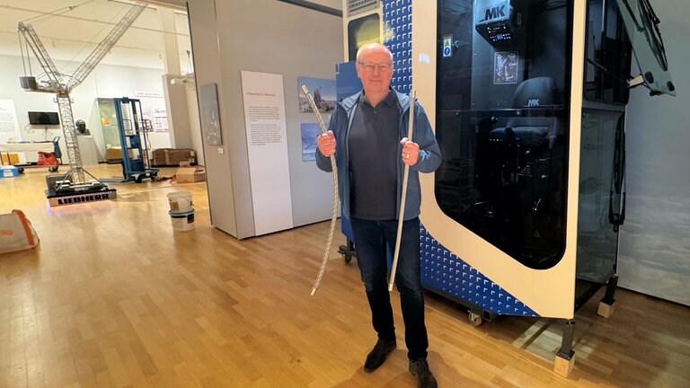 Museumsleiter Brunecker vor der Kabine eines Krans
