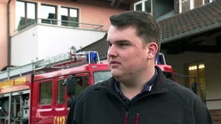 Philip Wenger steht vor einem Feuerwehrauto, das er ersteigert hat.