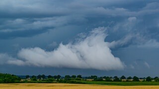 Gewitterwolken ziehen über die Landschaft.