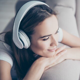 Frau hört Musik mit Kopfhörern
