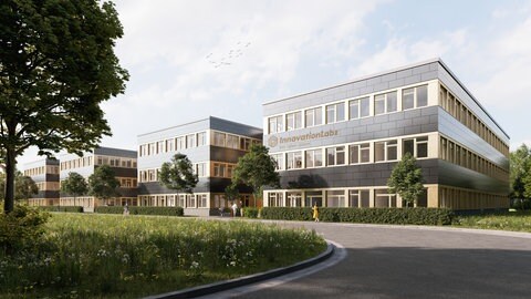 Ilustration, wie die Gebäude des Innovationlabz aussehen sollen: rechteckige graue Gebäude mit vielen Fenstern, davor wächst entlang einer Straße viel Grün