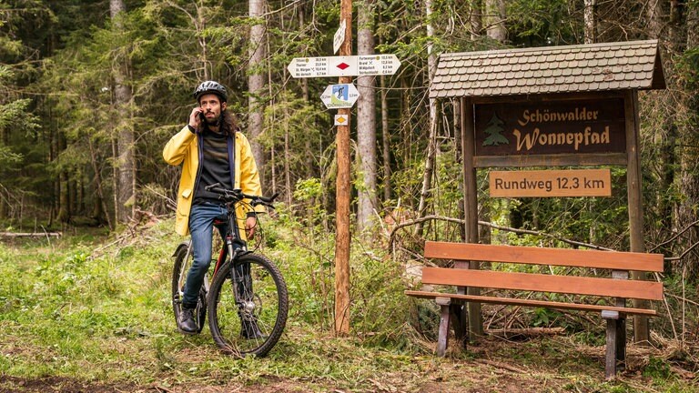 Albert sitzt auf seinem Fahrrad am Wonnepfad und telefoniert