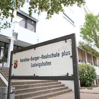 Schild und Gebaeude der Karolina-Burger-Realschule in Ludwigshafen am Rhein. 