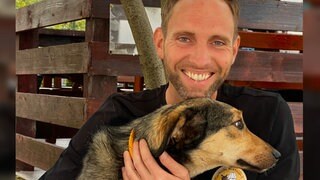Matthias Schmidt | Verein "Tierhilfe Hoffnung" und Leiter des weltgrößten Tierheims Smeura in PitestiRumänien, mit 6.000 Hunden und 450 Katzen. Er hält einen der Heimhunde auf dem Arm und stahlt in die Kamera.