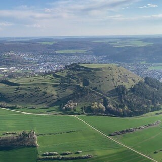 Der grüne Berg Ipf ist in der Bildmitte. Dahinter erstreckt sich die Stadt Bopfingen.