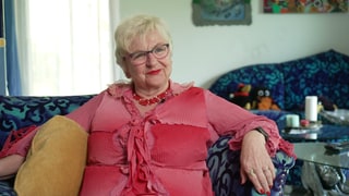 Single Christina sitzt auf dem Sofa.