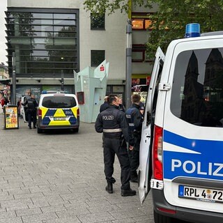 Blick in die Fußgängerzone in Koblenz: Einsatzfahrzeuge und Beamte bei der Großkontrolle der Polizei am 6. Mai 2026