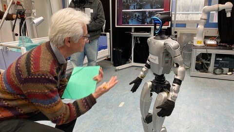 Der Roboter läuft auf SWR-Wissenschaftsredakteur Frank Wittig zu.
