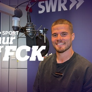 Jan Elvedi sitzt bei seinem Besuch im Podcast-Studio vor dem Mikrofon.
