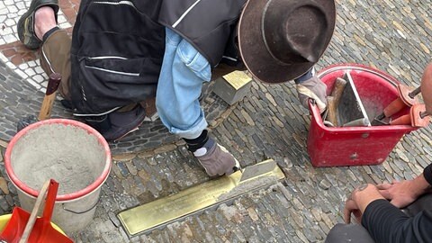 Arbeiter setzen die Stolperschwelle ein