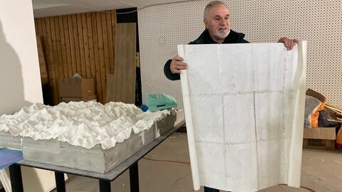 3D-Himalaya-Gebirge Nachbau in Metzingen. Künstler Panos Avramidis steht neben einem Teilsegment des Kunstwerkes. 