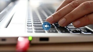 Eine Hand tippt auf einem Laptop.