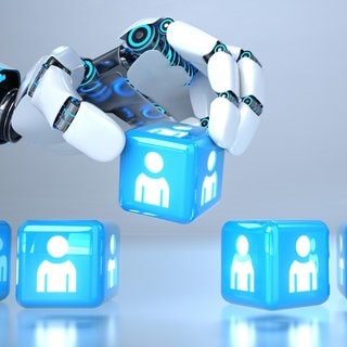 KI-Roboterhand wählt aus einer Reihe von Würfeln einen "Bewerber" aus: Entscheidet die KI über Karrierechancen?