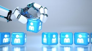 KI-Roboterhand wählt aus einer Reihe von Würfeln einen "Bewerber" aus: Entscheidet die KI über Karrierechancen?
