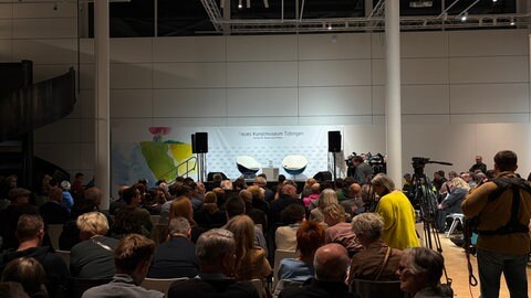 Volle Plätze vor dem noch leeren Podium im Neuen Kunstmuseum in Tübingen, auf dem sich Wolfgang Grupp und Gregor Gysi gleich unterhalten werden. 