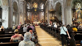 Gläubige sitzen auf den Bänken der Walldürner Wallfahrtsbasilika beim Gottesdienst