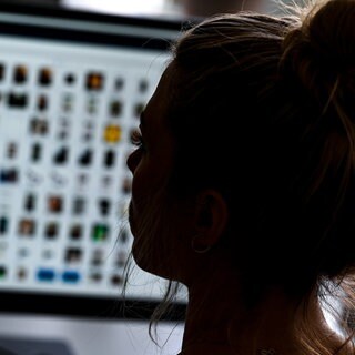 Ermittlerin vor einer Internetseite mit Kinderpornografie - hier könnte künftig KI bei der Datenauswertung helfen.