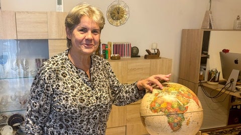 Sylvia Koch zeigt am Globus auf Bad Mergentheim. Hier fühlt sie sich wohl.