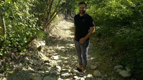 Claudius Wirth steht in dem ausgetrockneten Bachbett, wo vor einem Jahr das Wasser für eine Überflutung auf seinem Campingplatzt sorgte. 