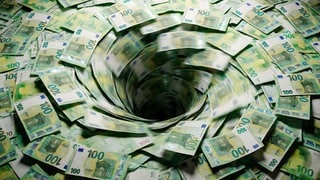 Mehrere 100-Euro-Scheine werden in einen Sog gezogen.
